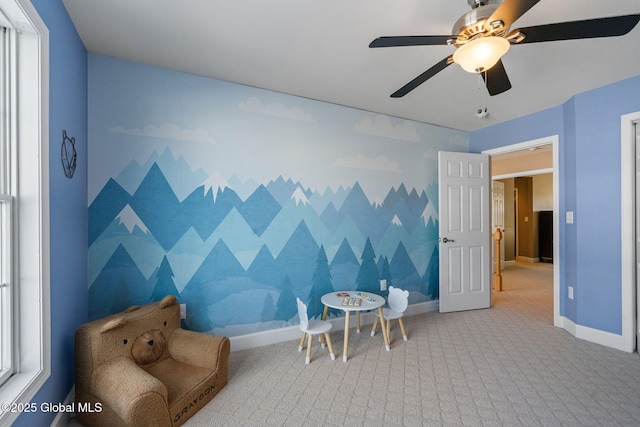 sitting room with ceiling fan, a healthy amount of sunlight, and carpet