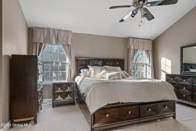 bedroom with lofted ceiling, light carpet, and ceiling fan