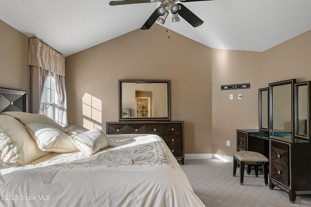 carpeted bedroom with vaulted ceiling and ceiling fan