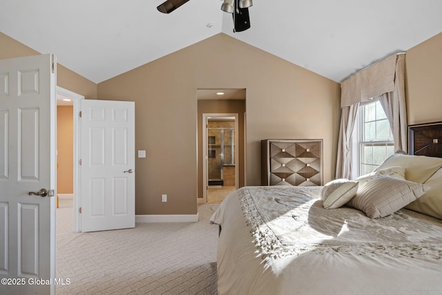 carpeted bedroom with ceiling fan, ensuite bathroom, and vaulted ceiling