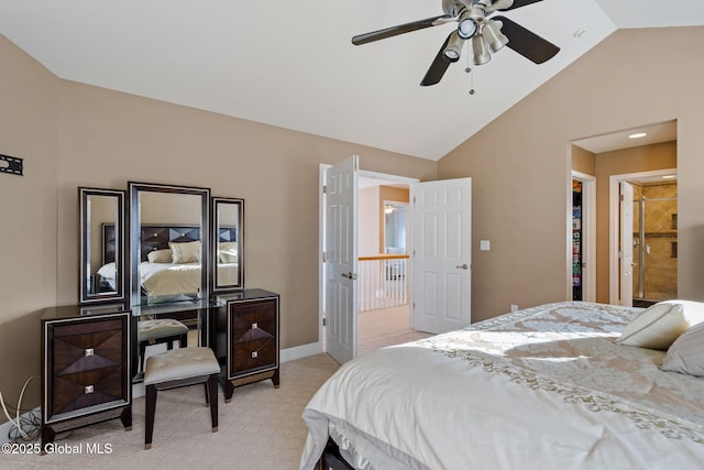 bedroom featuring a walk in closet, vaulted ceiling, light colored carpet, a closet, and ceiling fan