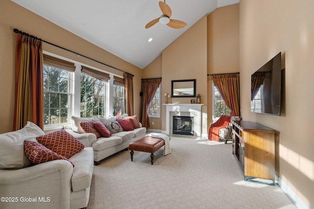 living room with high vaulted ceiling, carpet floors, and ceiling fan