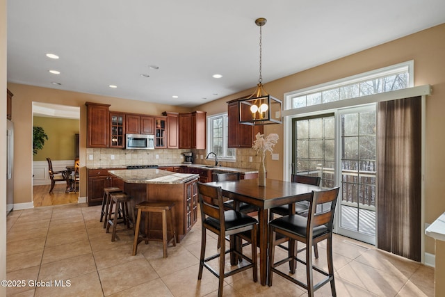 tiled dining room featuring sink