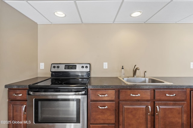 kitchen with stainless steel electric range oven, sink, and a drop ceiling