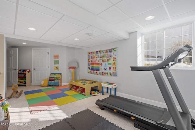 playroom with carpet flooring and a drop ceiling