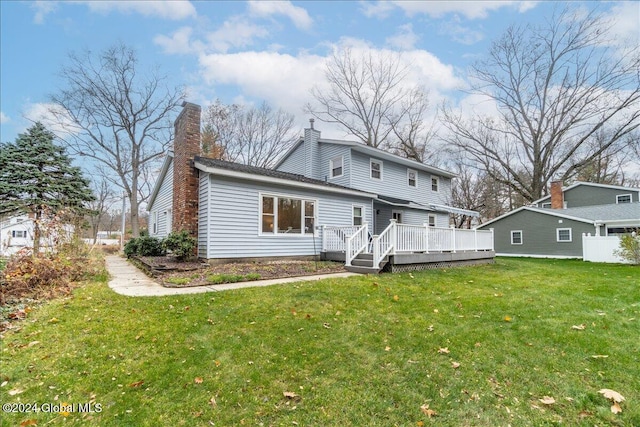 back of house with a yard and a deck