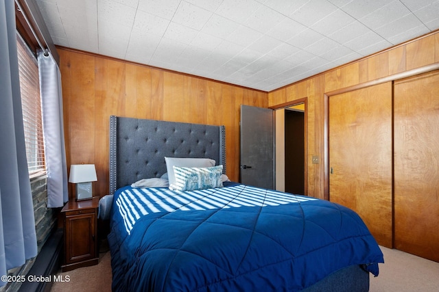 carpeted bedroom with wooden walls and a closet