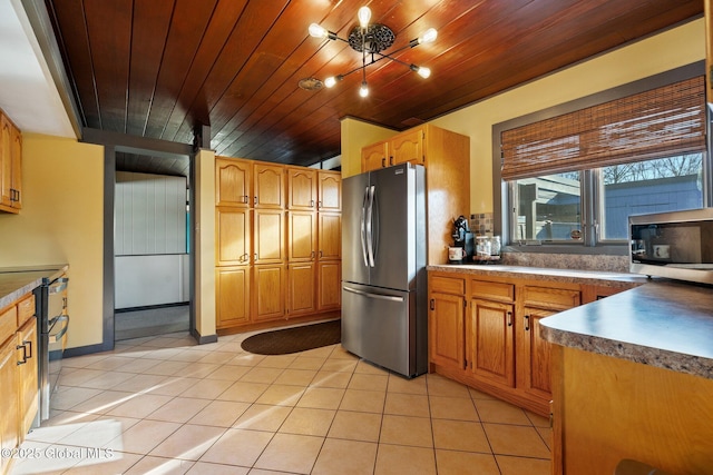 kitchen featuring wood ceiling, stainless steel appliances, and light tile patterned floors