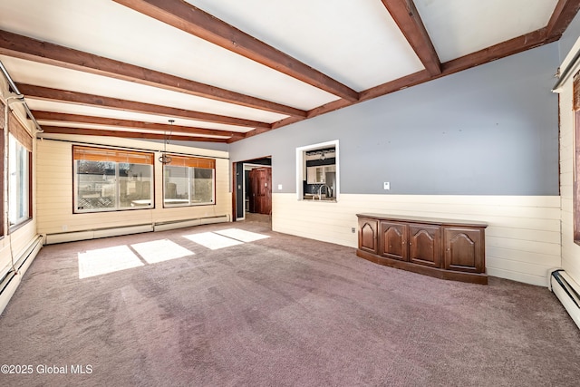 unfurnished living room with baseboard heating, carpet floors, and beamed ceiling