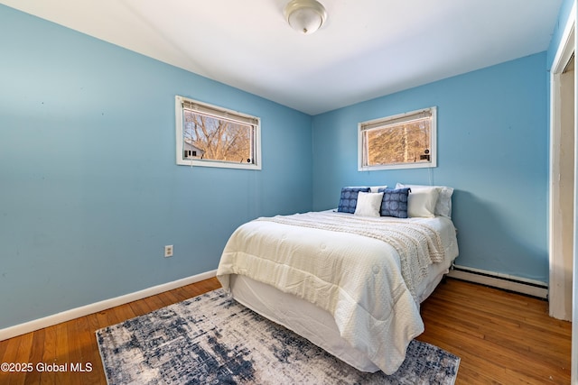 bedroom featuring a baseboard radiator and wood-type flooring