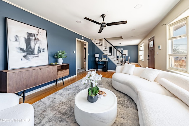 living room with ceiling fan and light wood-type flooring