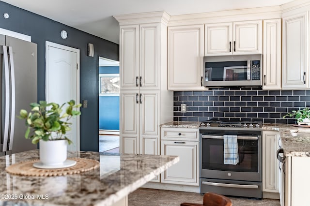 kitchen featuring light stone counters, appliances with stainless steel finishes, baseboard heating, and backsplash