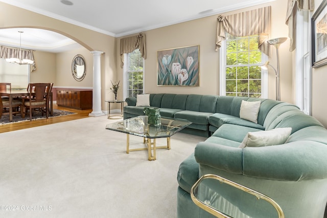 carpeted living room with ornamental molding and ornate columns