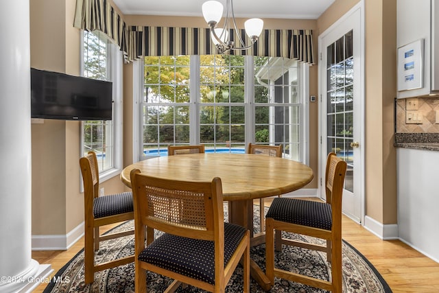 dining room featuring an inviting chandelier and light wood-type flooring