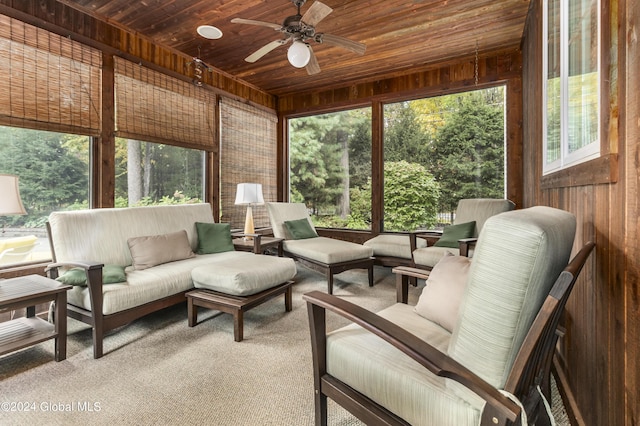 sunroom / solarium featuring wood ceiling and ceiling fan