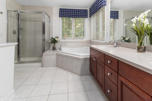 bathroom with vanity, a wealth of natural light, tile patterned floors, and shower with separate bathtub