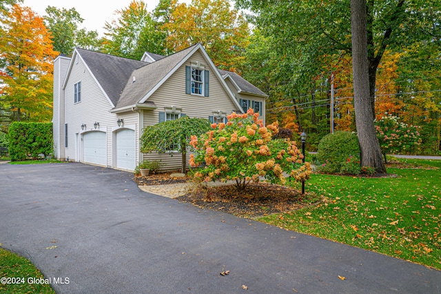 view of property exterior with a yard and a garage