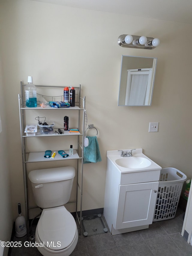 bathroom featuring vanity, tile patterned floors, and toilet