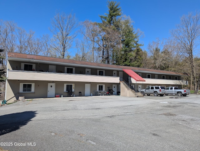 view of property featuring uncovered parking