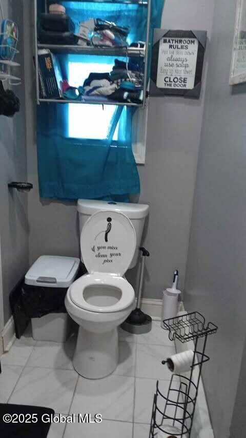 bathroom featuring tile patterned floors and toilet