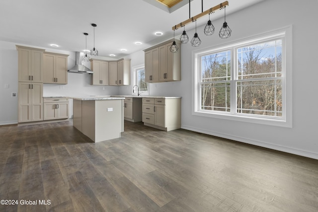 kitchen with dark hardwood / wood-style floors, hanging light fixtures, a center island, and wall chimney exhaust hood