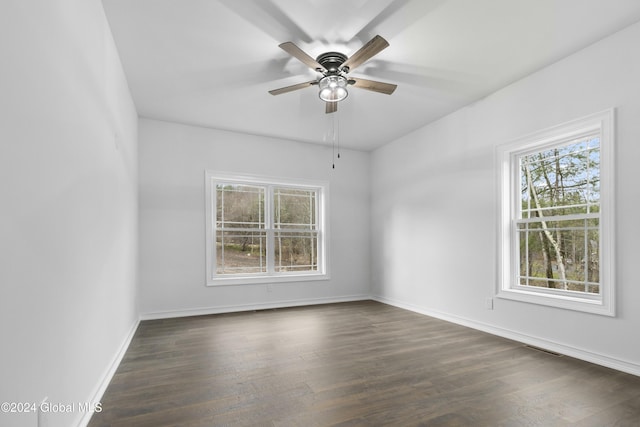 empty room featuring ceiling fan and dark hardwood / wood-style floors