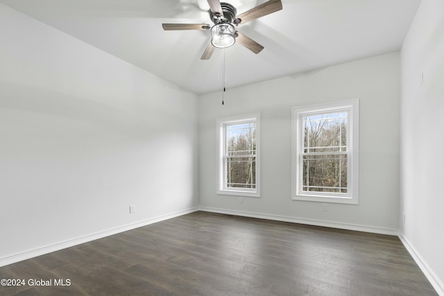 spare room featuring ceiling fan and dark wood-type flooring