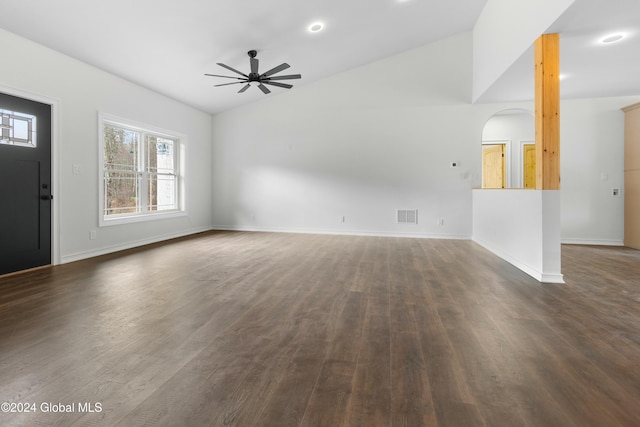 unfurnished living room featuring dark hardwood / wood-style flooring, ceiling fan, and vaulted ceiling