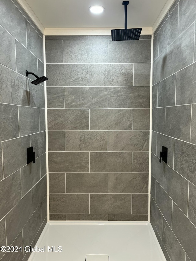 bathroom with a tile shower