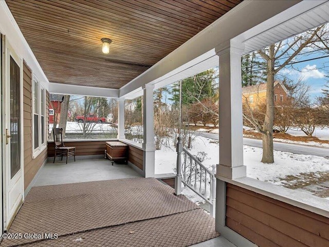 unfurnished sunroom featuring wood ceiling