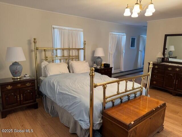 bedroom with a notable chandelier, crown molding, a baseboard radiator, and light wood-type flooring