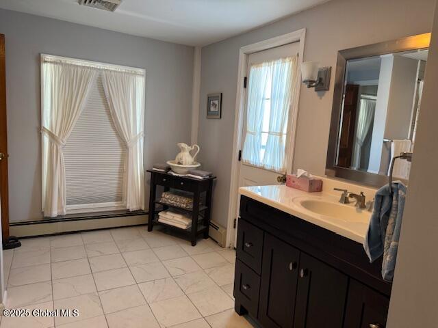 bathroom with baseboard heating, tile patterned floors, and vanity