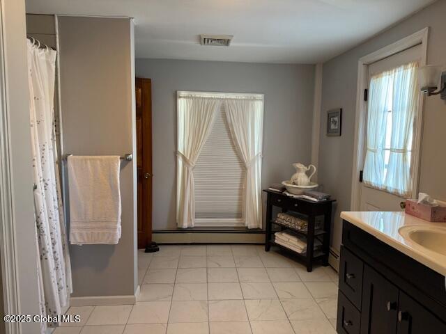 bathroom with vanity and a baseboard radiator