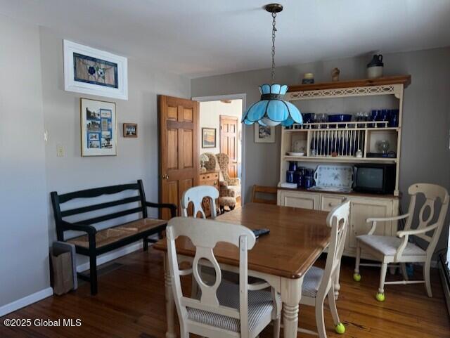 dining room with dark hardwood / wood-style flooring