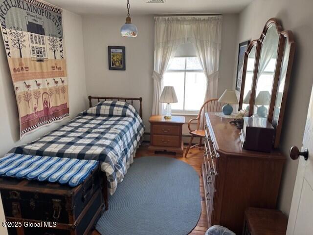 bedroom with wood-type flooring