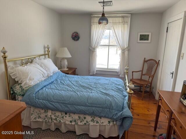 bedroom with wood-type flooring