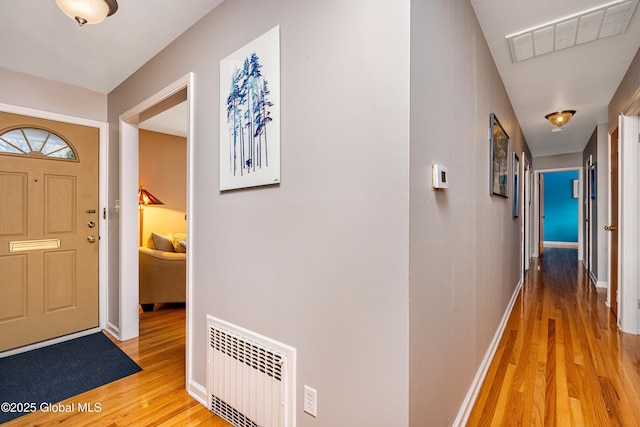 foyer with hardwood / wood-style flooring and radiator