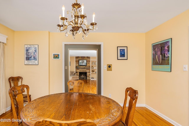 dining space with wood-type flooring and a fireplace