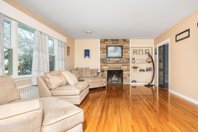 living room with wood-type flooring and a fireplace