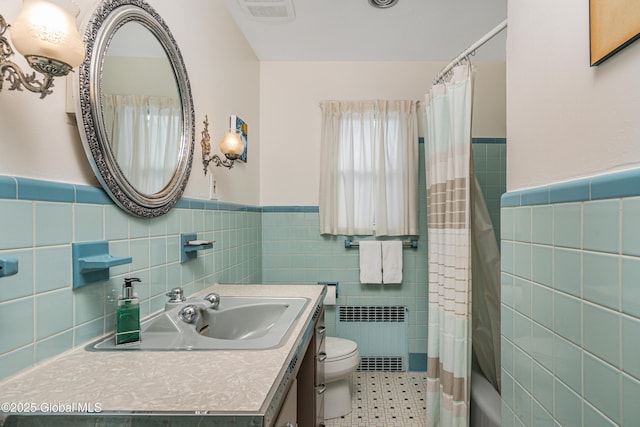 full bathroom with shower / tub combo with curtain, toilet, tile walls, radiator heating unit, and vanity