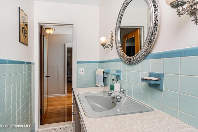 bathroom featuring vanity and tile walls