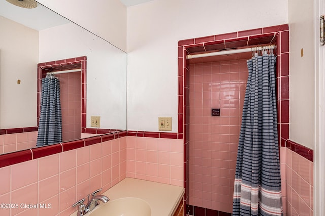 bathroom with sink and tile walls