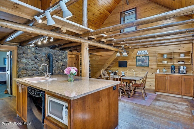 kitchen with an island with sink, black dishwasher, sink, hardwood / wood-style flooring, and wooden ceiling