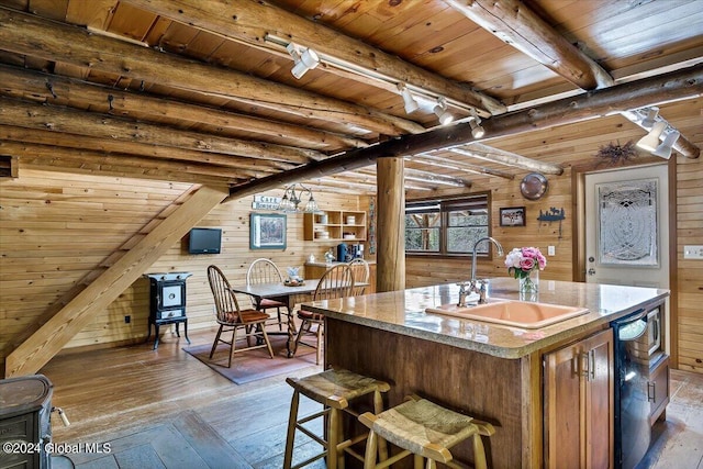 bar featuring sink, light wood-type flooring, wooden ceiling, wooden walls, and beamed ceiling