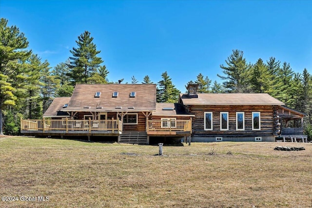 back of house with a yard and a deck