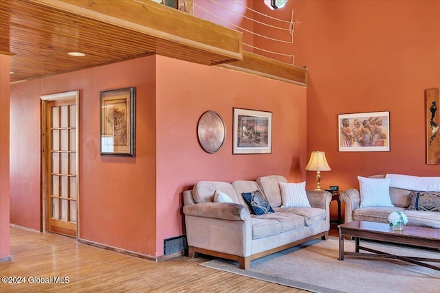 living room featuring hardwood / wood-style flooring and wooden ceiling