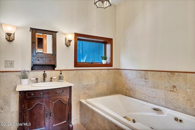 bathroom with vanity, tiled bath, and tile walls