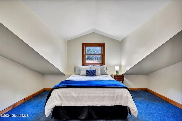 bedroom with lofted ceiling and carpet floors