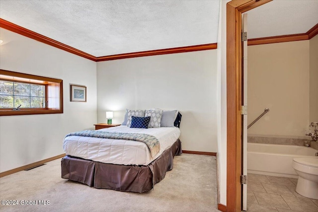 carpeted bedroom with ornamental molding and a textured ceiling