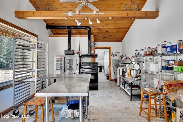 kitchen featuring vaulted ceiling, black gas range oven, range hood, wood ceiling, and ceiling fan